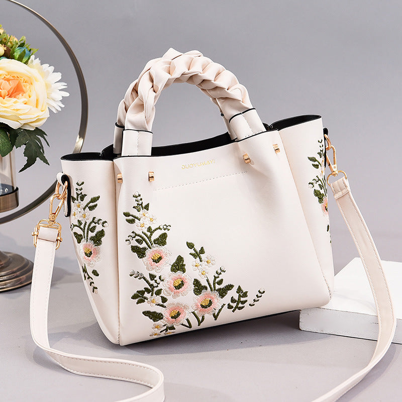 Front view of the women's shopping tote shoulder bag displayed flat on a clean background