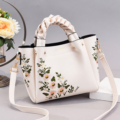 Front view of the women's shopping tote shoulder bag displayed flat on a clean background
