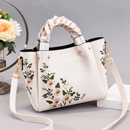 Front view of the women's shopping tote shoulder bag displayed flat on a clean background